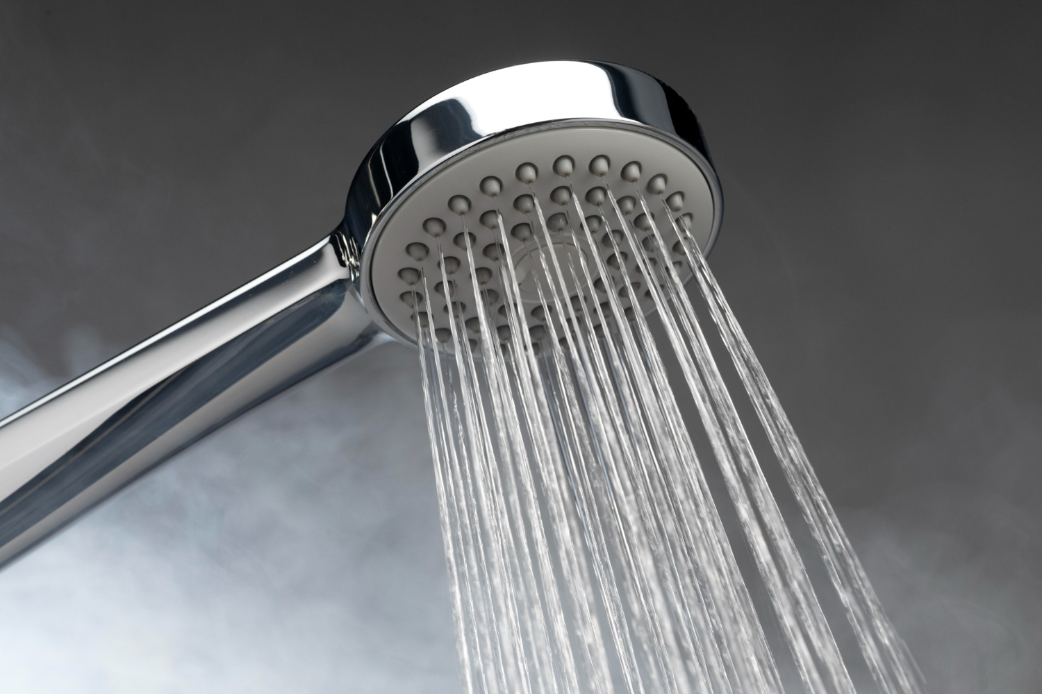 HVAC Blog 1 Showerhead with water flowing, illustrating low hot water pressure issues relevant to HVAC concerns in Easton homes.